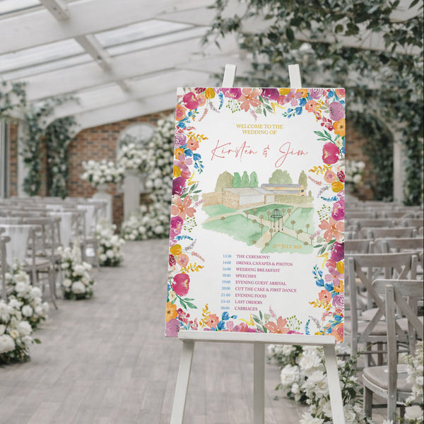 Decorated wedding venue with a floral-themed welcome sign on an easel.